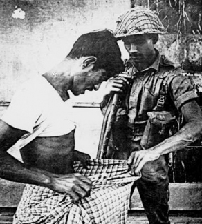west pakistani soldier searching an east pakistani bengali in dacca June 1971